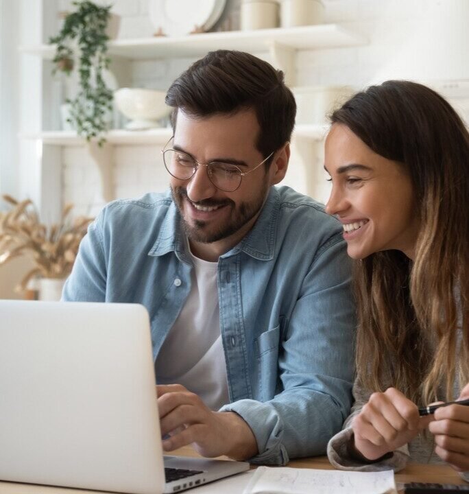 A couple reading about loan options